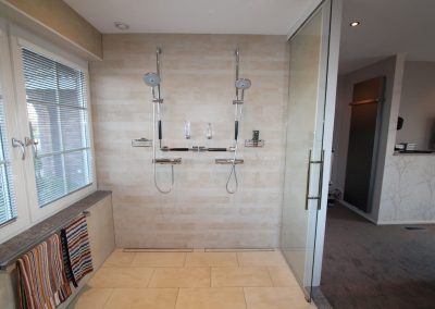 Minder-valide badkamer met dubbele douche in garage gebouwd